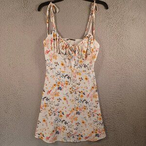 Women's multi-colored floral print spaghetti strap dress with tie-up design.